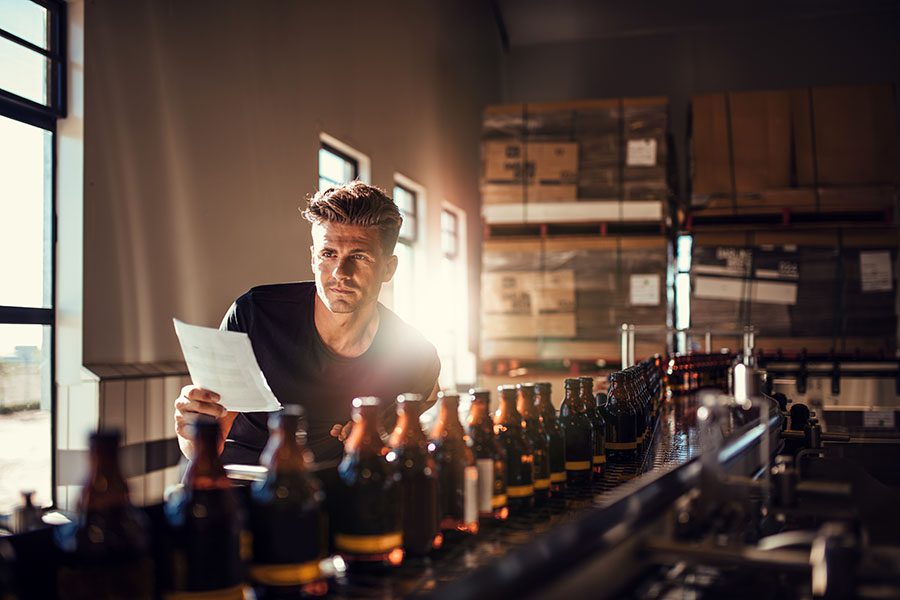 Specialized Business Insurance - Man Checking Production Quality At Brewery